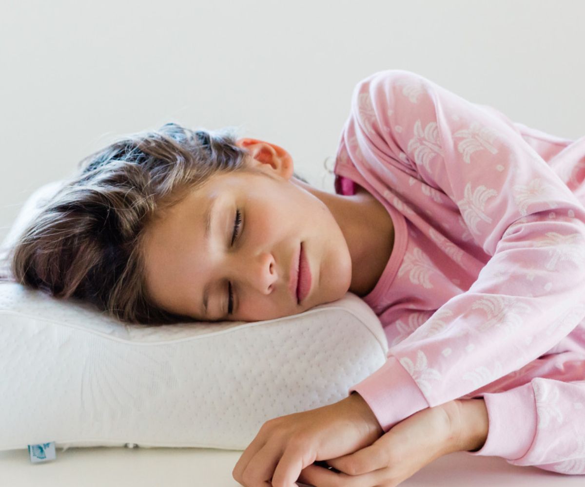 girl sleeping on her adjustable kids pillow