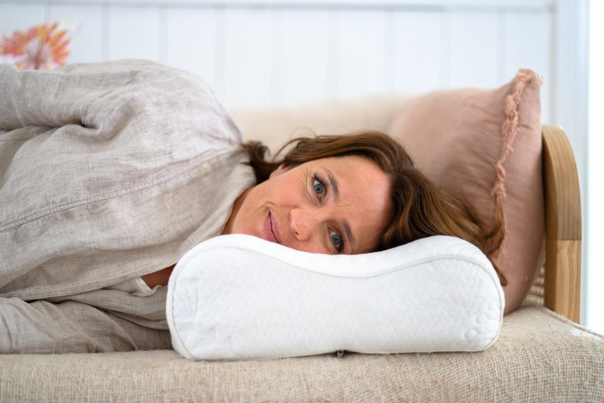 Lone asleep on her side on a Posture Form contour pillow