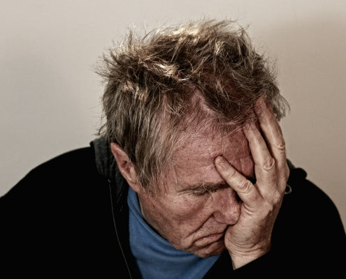 Man experiencing chronic pain and sleep deprivation - Posture Form Pillows