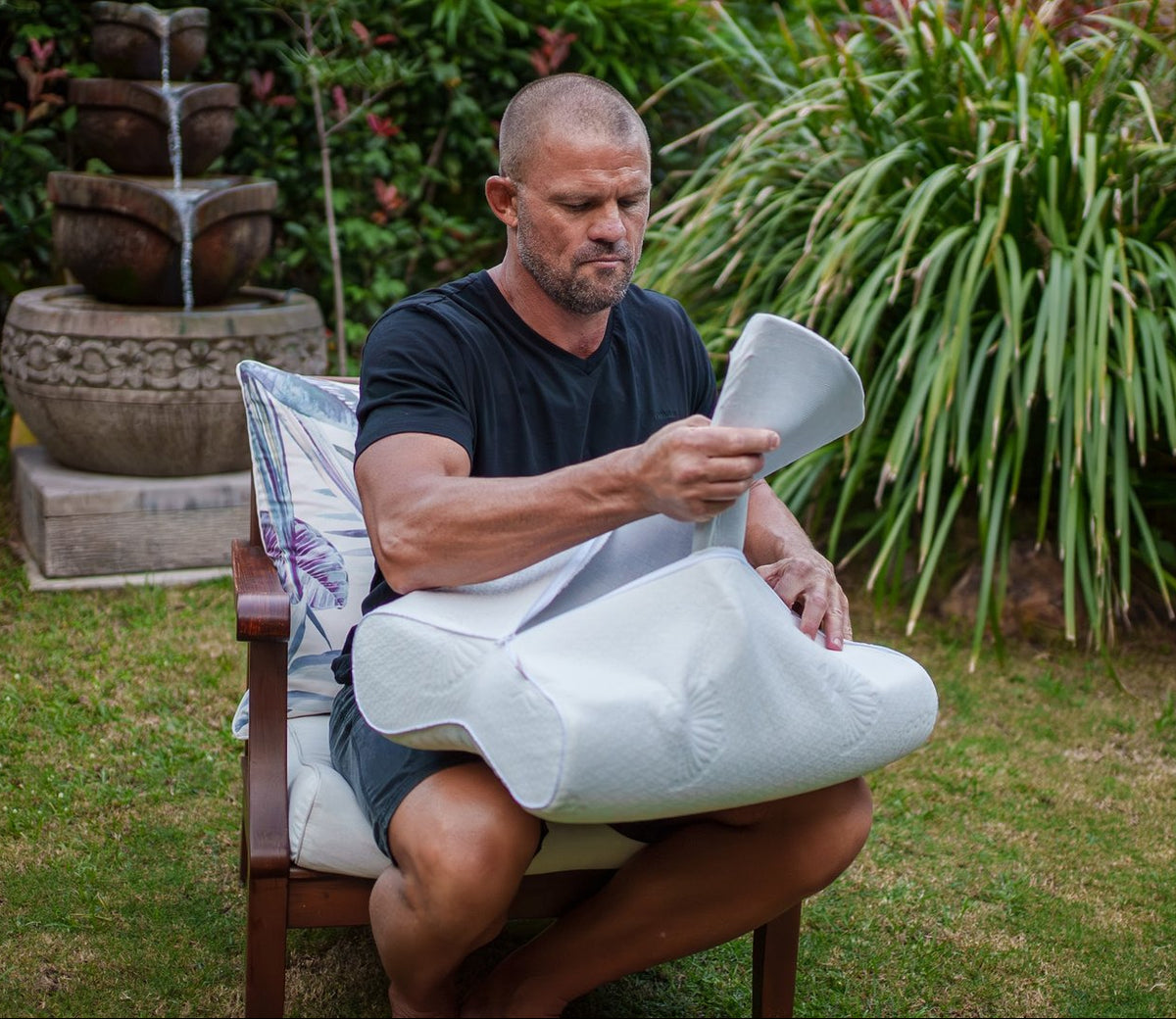 Andrew lifting the adjustable height insert out of a Posture Form pillow