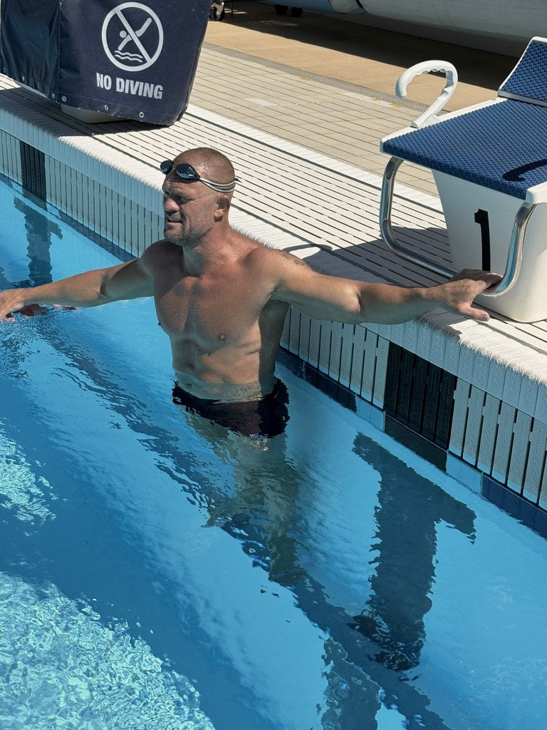Andrew resting his arms on the pool edge during his daily swim
