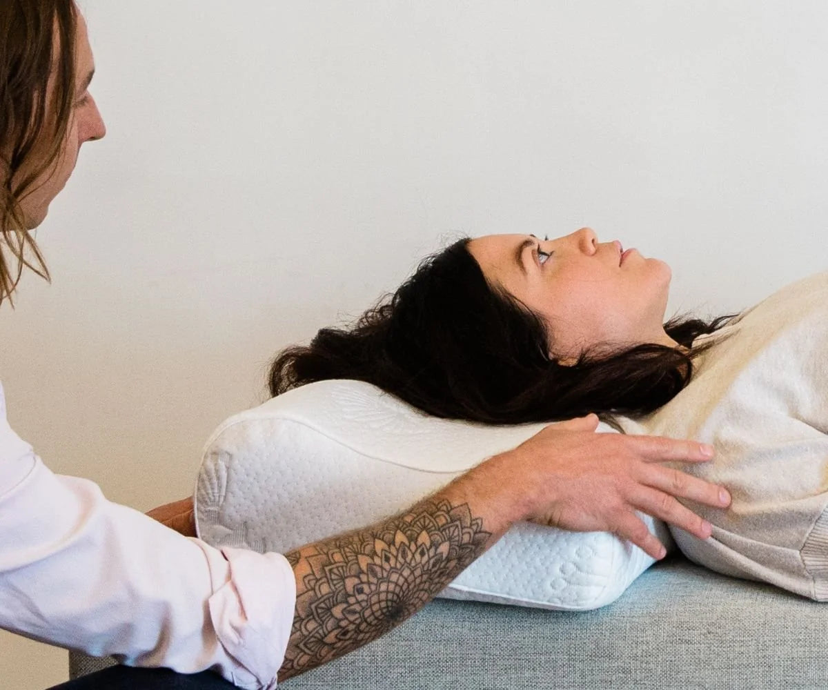 Chiropractor adjusting ergonomic posture pillow for back sleeper alignment and neck support