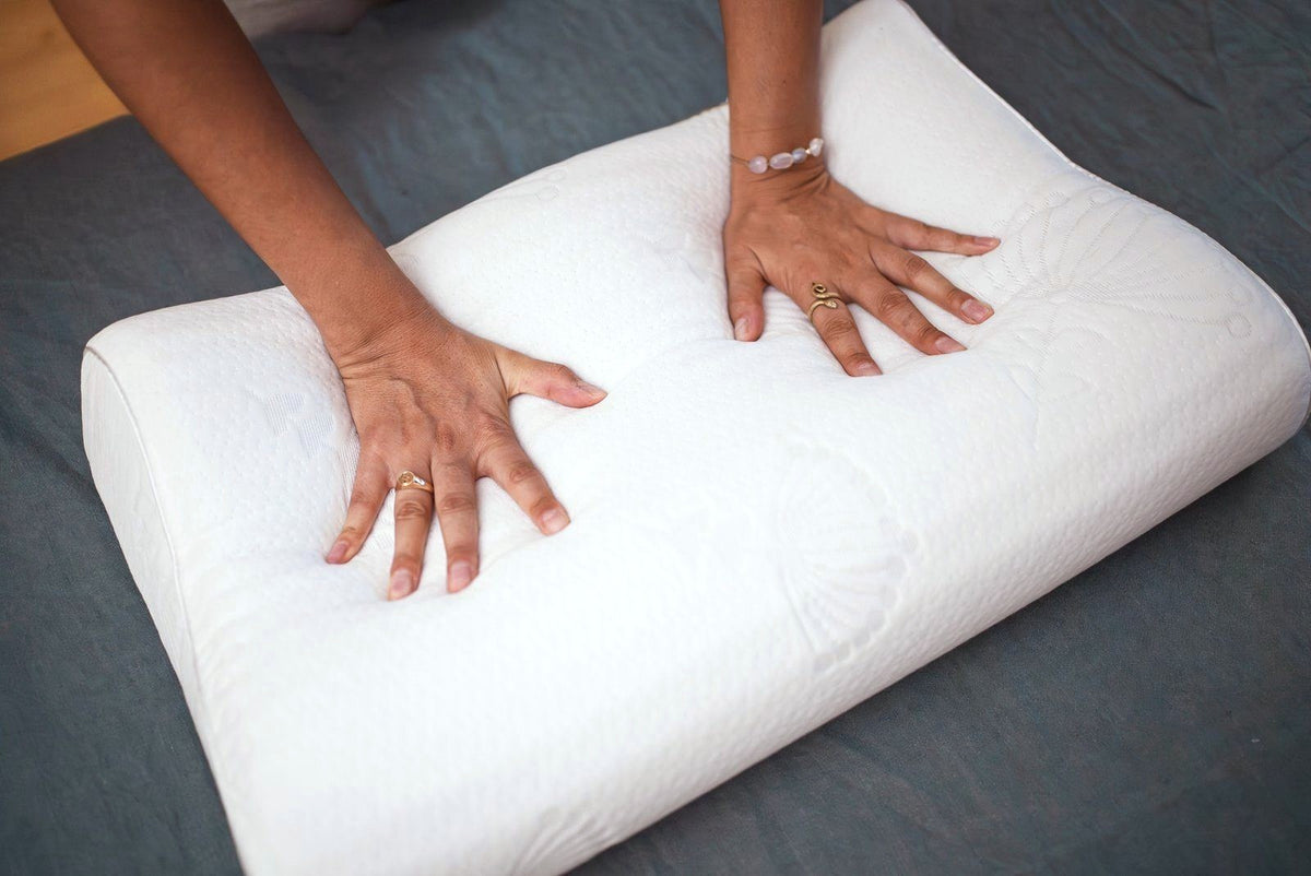 Hands pressing into a Posture Form contour pillow