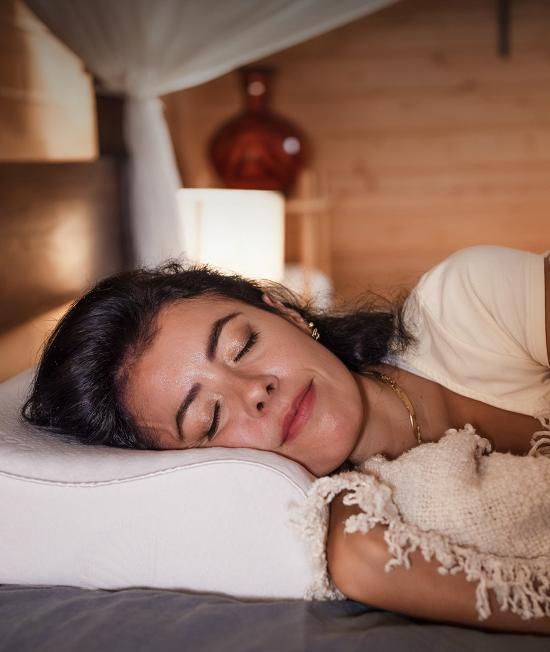 Woman asleep on her side on the Posture Form contoured pillow