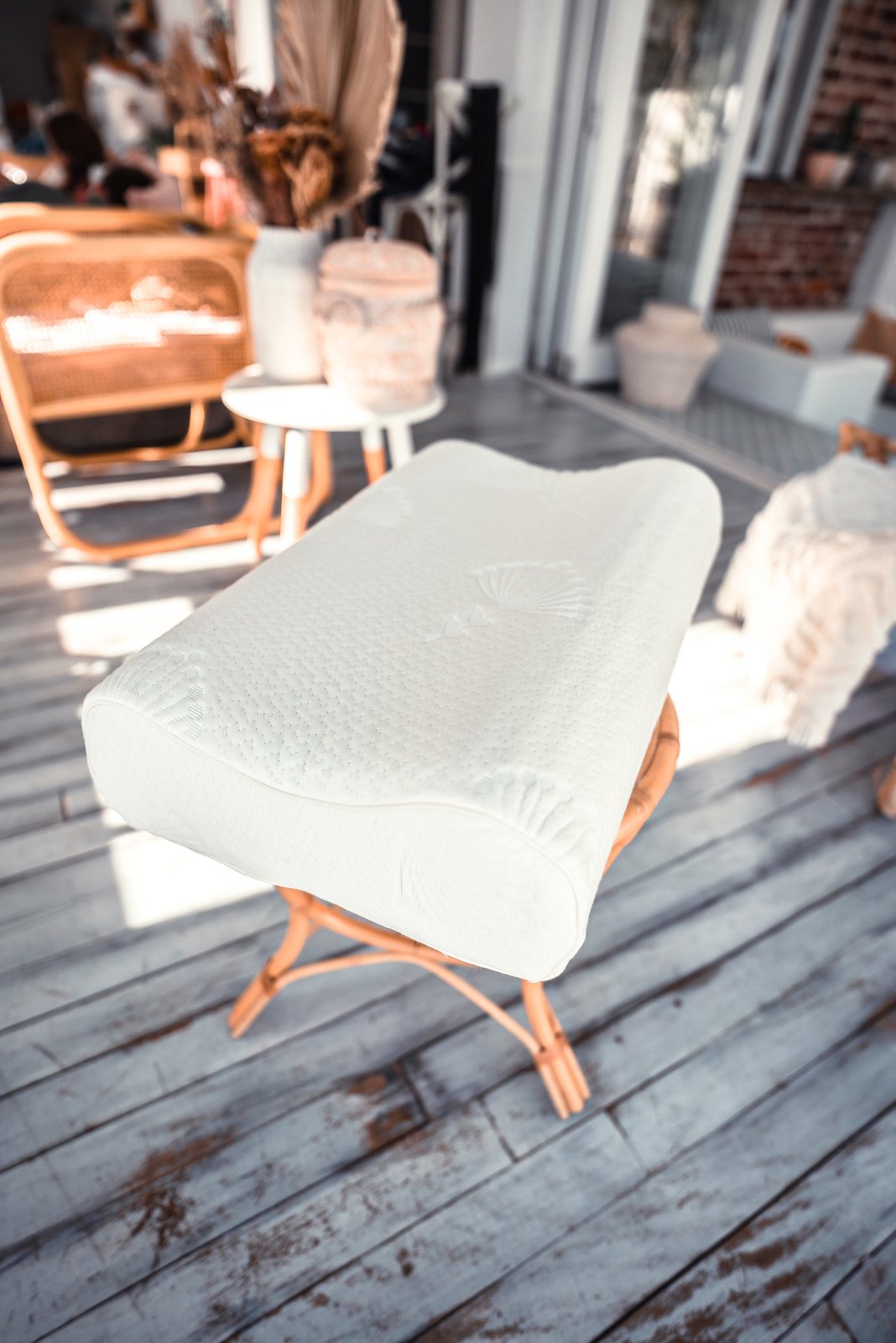 A Posture Form contour pillow made from Australian-made NexGen foam, on a timber stand